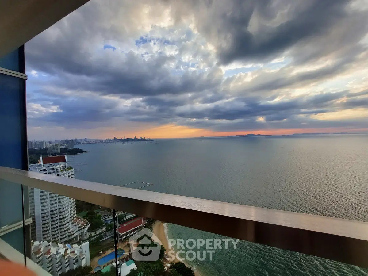 Stunning ocean view from high-rise balcony at sunset, perfect for luxury living.