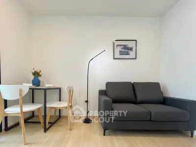 Modern living room with sleek sofa and dining area in minimalist apartment