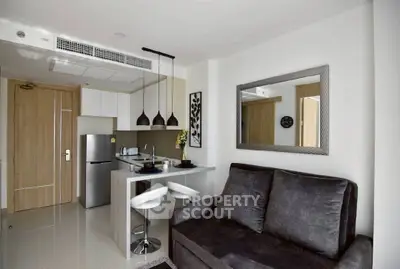 Modern open-layout kitchen and living room with sleek furniture and stylish decor.
