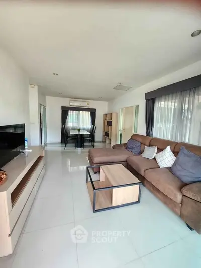 Spacious modern living room with stylish furniture and large windows for natural light.