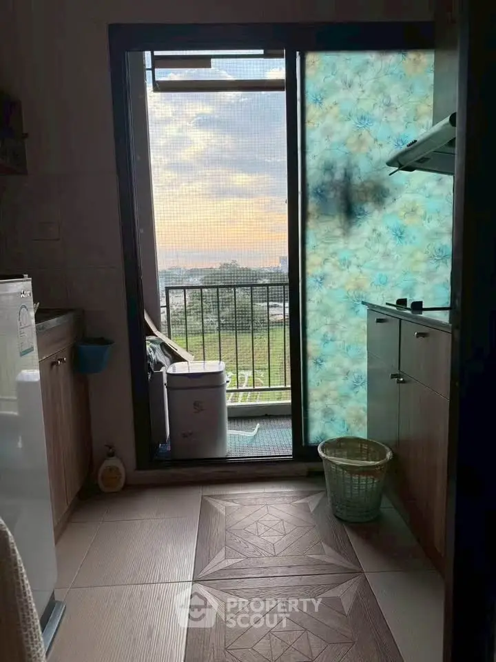 Charming kitchen with balcony view, featuring modern appliances and stylish cabinetry.