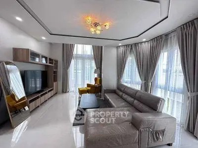 Spacious modern living room with large windows and elegant decor