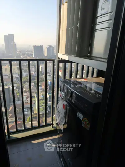 High-rise balcony with city view and modern washing machine, perfect for urban living.