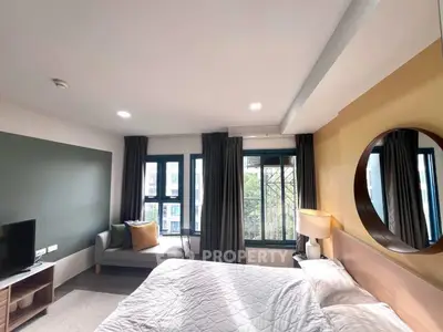 Modern bedroom with large windows and stylish decor in urban apartment