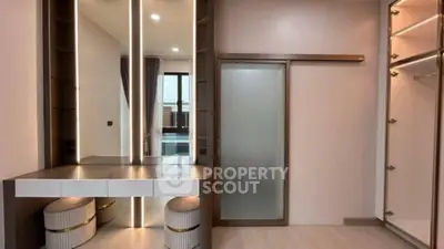 Luxurious walk-in closet with modern vanity and ample storage space