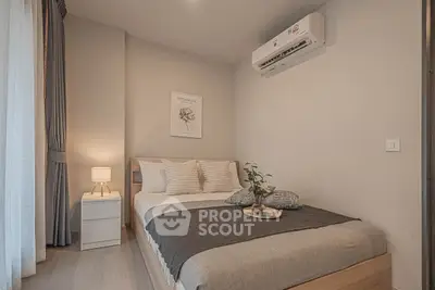 Cozy bedroom with modern decor and air conditioning, perfect for relaxation.