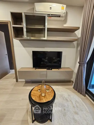 Modern living room with sleek TV unit and air conditioning, perfect for cozy relaxation.