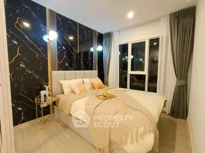 Luxurious bedroom with elegant decor and large window offering stunning city views.