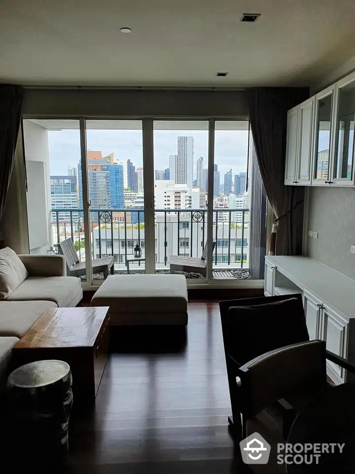 Spacious living room with city view and large balcony access