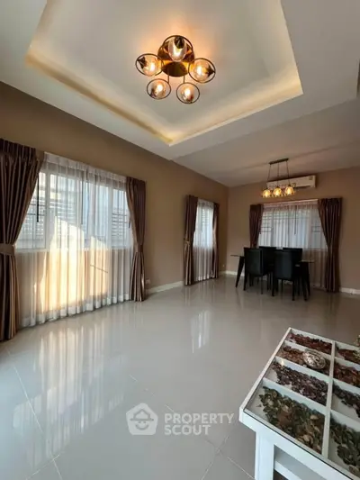 Spacious modern living room with elegant lighting and large windows