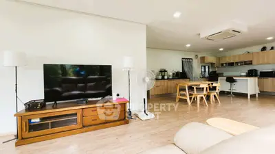 Spacious open-plan living room with modern kitchen and stylish wooden furniture.