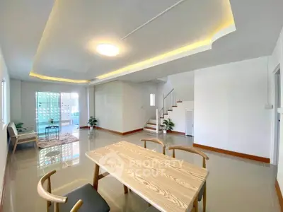 Spacious modern living room with elegant staircase and natural light