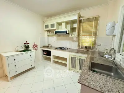 Charming kitchen with gas stove and ample storage, perfect for culinary enthusiasts.