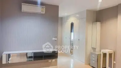 Spacious modern bedroom with built-in wardrobe and air conditioning unit