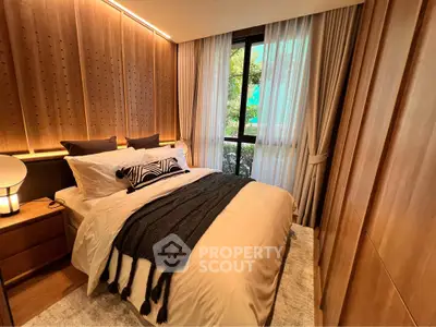 Luxurious bedroom with elegant wood paneling and large window offering serene garden view.