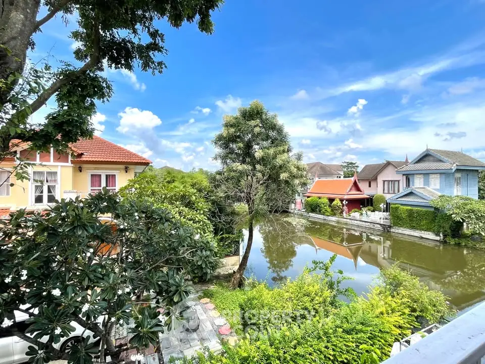 Charming suburban homes with serene pond view and lush greenery