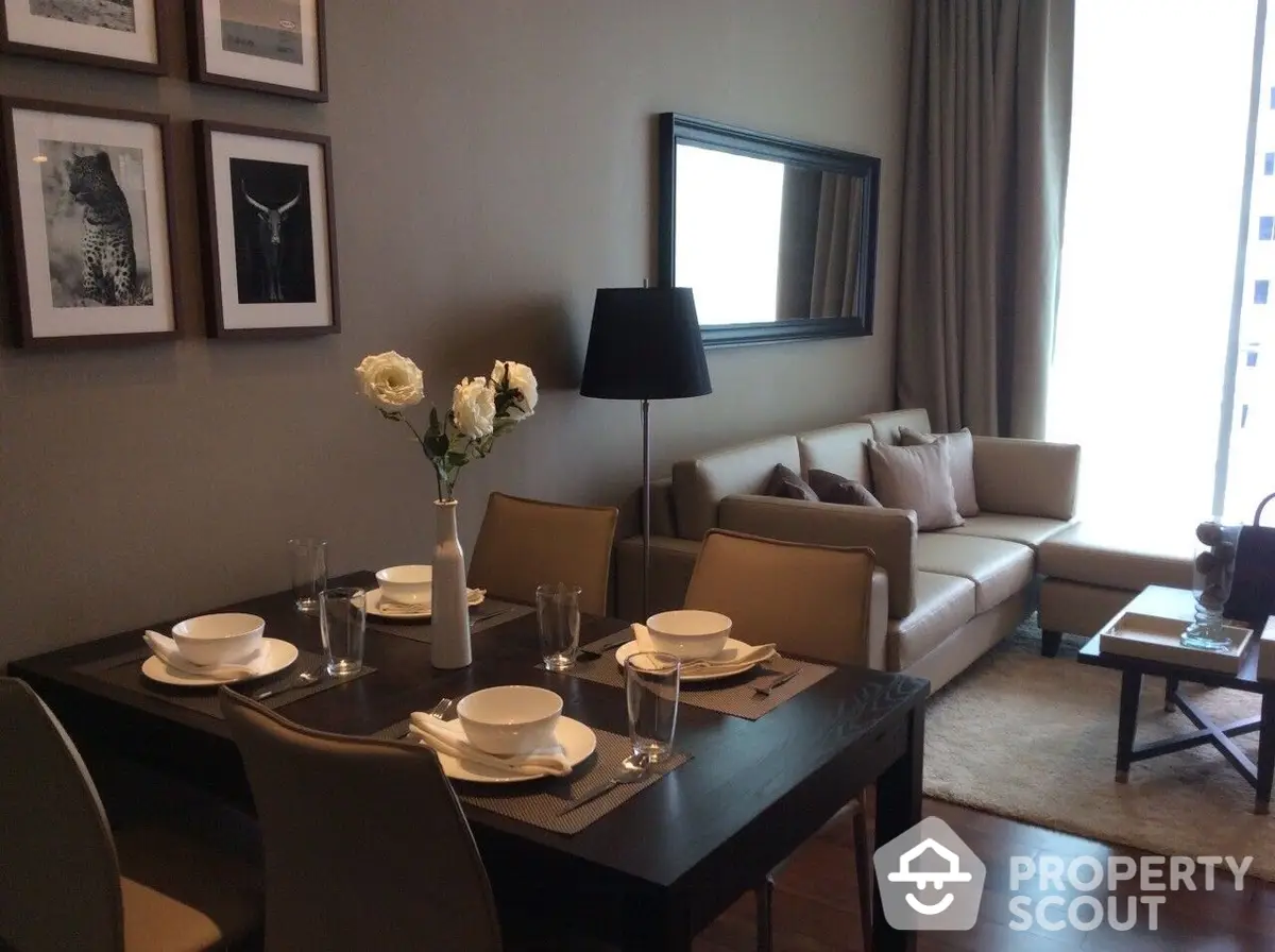 Elegantly furnished living room with dining area, showcasing a modern design palette, sophisticated furniture, and tasteful decor, ideal for urban living.