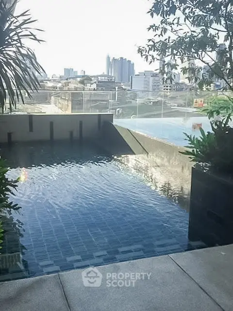 Luxurious rooftop pool with stunning cityscape views and lush greenery.