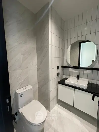 Modern bathroom with sleek design and round mirror