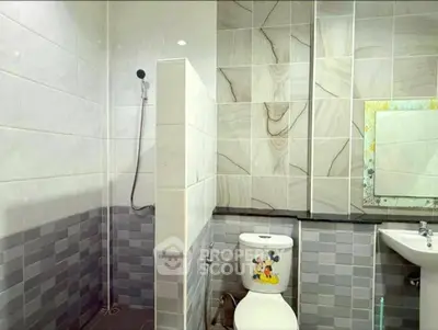 Modern bathroom with stylish tiles and shower area