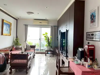 Spacious living room with elegant wooden furniture and large window view.