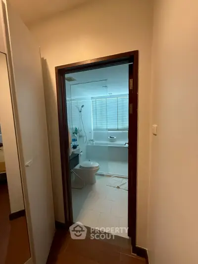 Cozy bathroom with modern fixtures and shower, perfect for a comfortable living space.