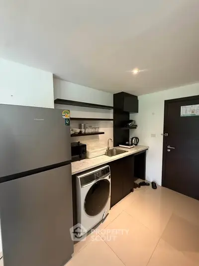 Modern kitchen with sleek appliances and compact design
