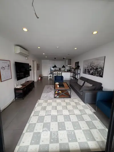 Spacious modern living room with open kitchen layout and stylish decor