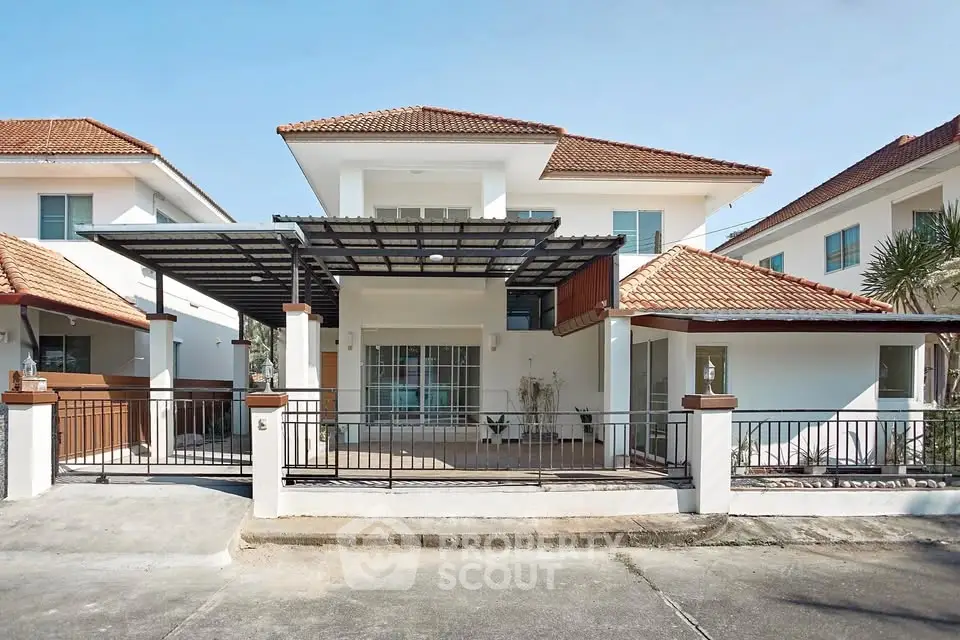 Stunning two-story house with modern design and spacious outdoor area in a serene neighborhood.