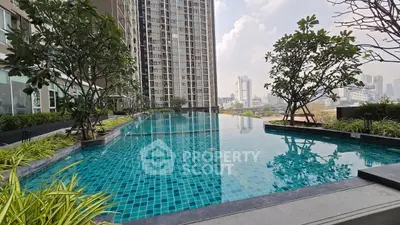 Luxurious high-rise apartment with stunning rooftop pool and city views.