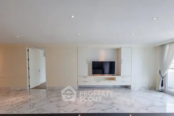 Spacious modern living room with marble flooring and built-in TV unit