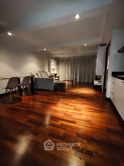 Spacious living room with elegant wooden flooring and modern furniture