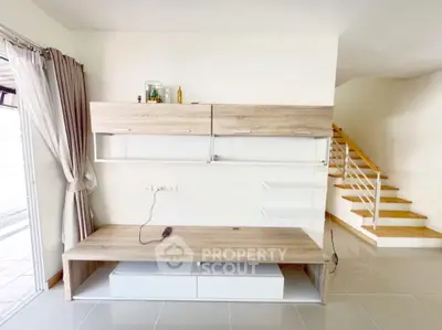 Modern living room with stylish wooden furniture and staircase