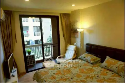 Cozy bedroom with balcony access in modern apartment