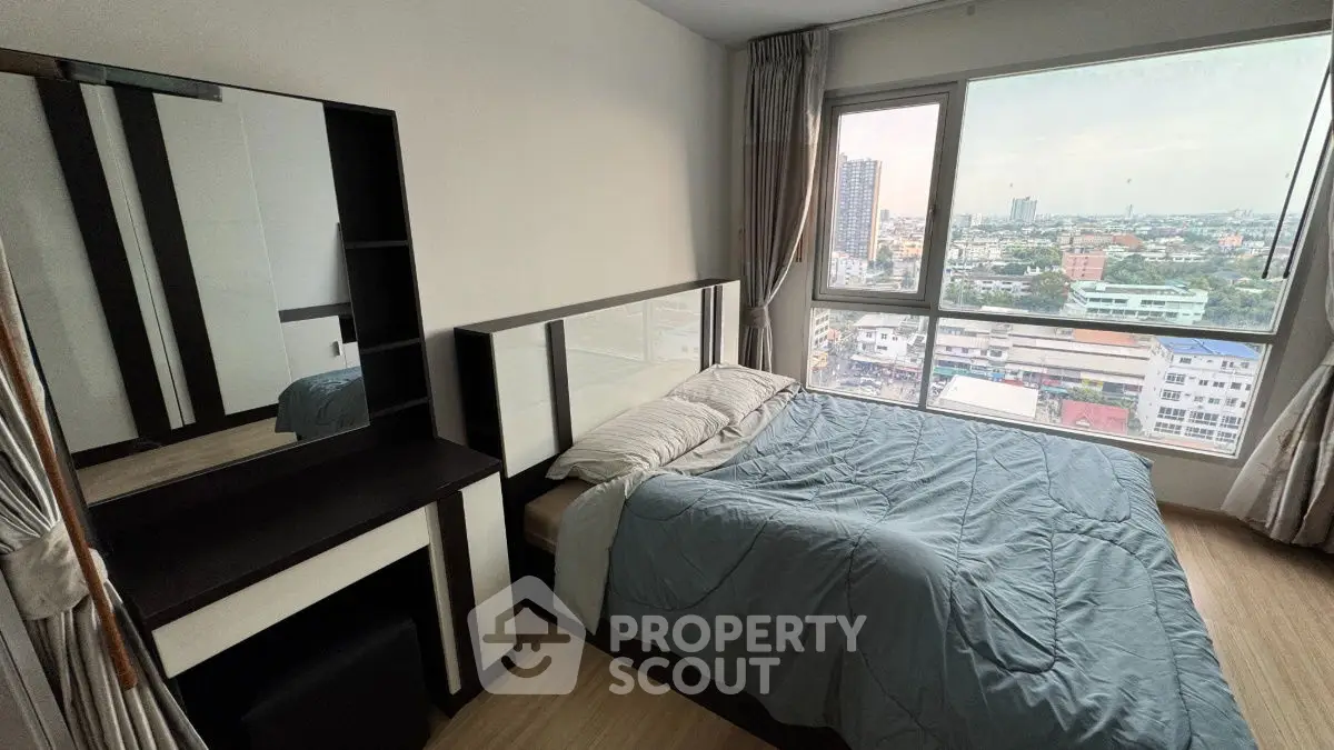 Modern bedroom with large window offering stunning city view