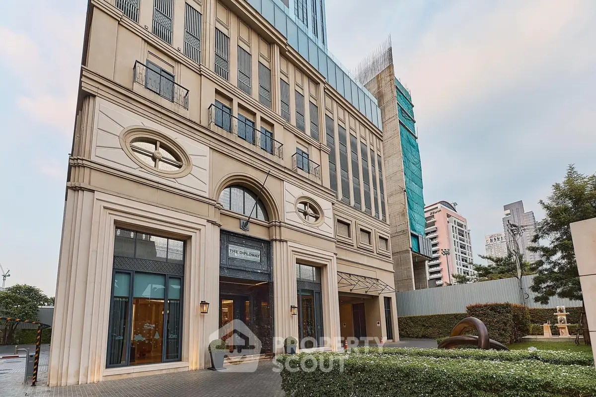 Elegant building exterior with classic architecture and lush landscaping in urban setting.