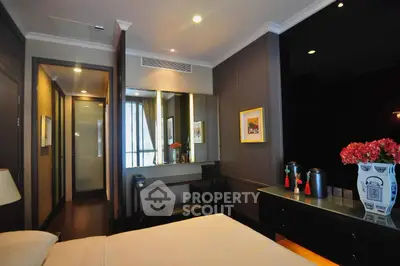 Luxurious bedroom with elegant decor and modern furnishings, featuring a stylish vanity and ambient lighting.