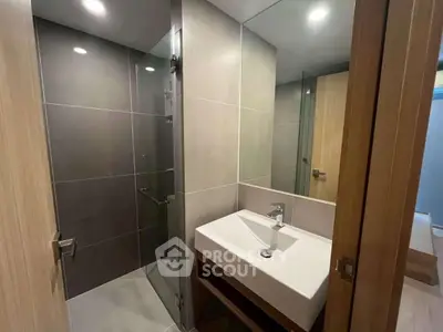 Modern bathroom with sleek design and spacious shower area.
