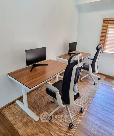 Modern home office with ergonomic chairs and dual desks, perfect for productivity and comfort.