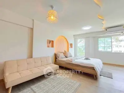 Spacious bedroom with modern decor and natural light