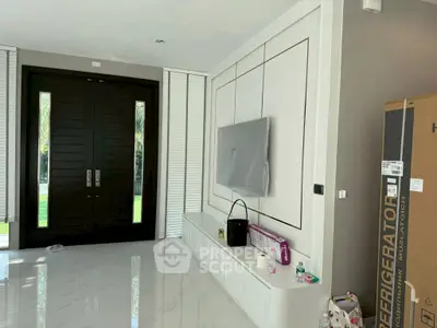 Spacious modern living room with sleek design and large black double doors