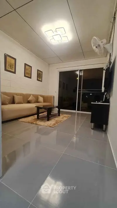Modern living room with sleek tiles and cozy seating area