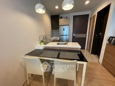 Modern kitchen with sleek design and dining area in contemporary apartment