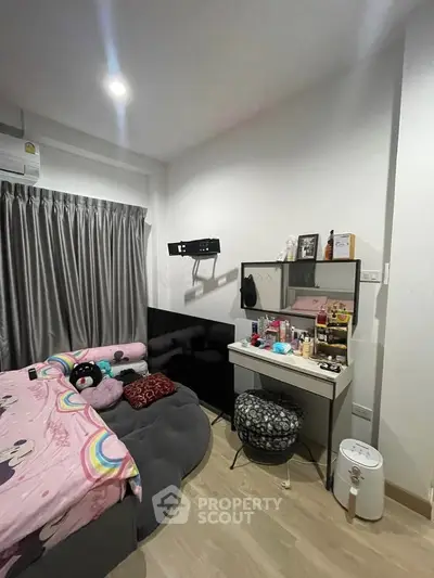 Cozy bedroom with stylish decor and ample natural light