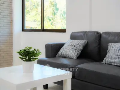 Modern living room with sleek gray sofa and bright natural light