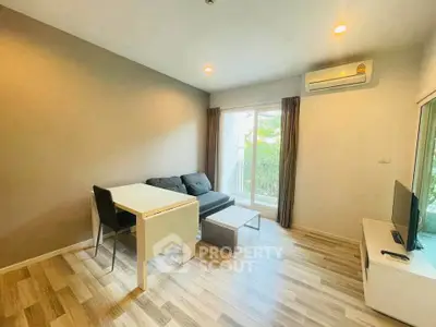 Modern living room with sleek furniture and natural light, featuring a cozy sofa and stylish decor.