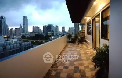 Stunning cityscape view from spacious balcony in modern high-rise apartment.