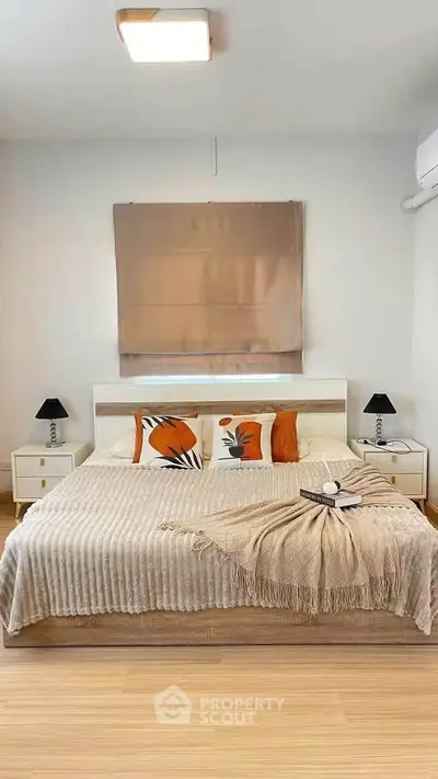 Modern bedroom with stylish decor and cozy bedding in a contemporary apartment.