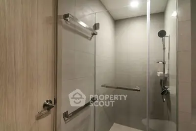 Modern bathroom with glass shower enclosure and sleek fixtures