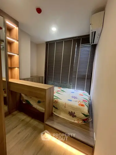 Cozy bedroom with modern wooden furniture and ambient lighting, perfect for a comfortable living experience.